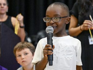 A student speaks into a mic