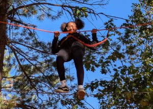 Student smiles while on a rope course
