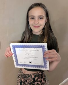 Student poses with certificate 