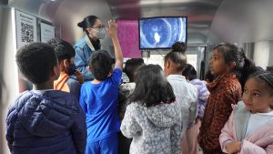 students looking at what's under the microscope on a large screen 