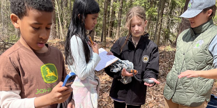Students analyze data collected during an outdoors field trip to the Mabee Farm.