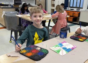art student smiling while painting