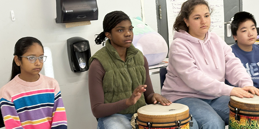 Students play drums