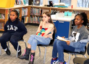 Students listen in a circle
