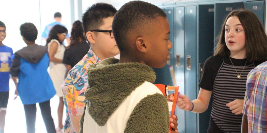 students standing outside their lockers