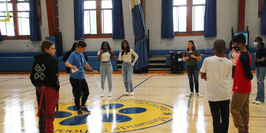 students standing on gym floor