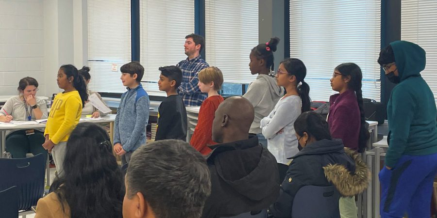 parents sitting in classroom and students lined up