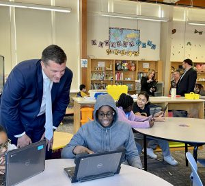 Fifth grade student shows Senator-elect Ashby his coding project