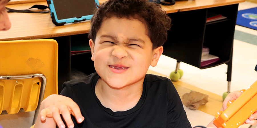 A young scholar makes a funny face for the camera during a recent class.