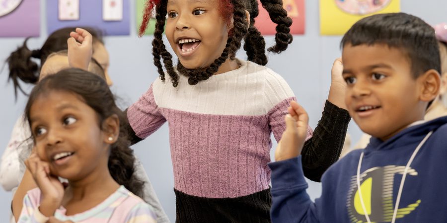 A student jumps and smiles