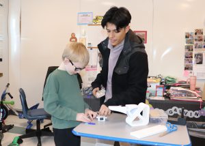 student and college student play with a gadget