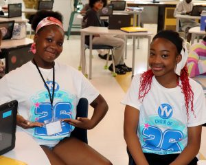 Students pose while wearing American Young Voices Tee Shirts