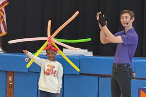 Kid wears balloon hat