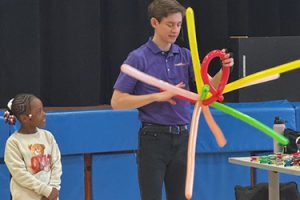 Guy makes balloon hat