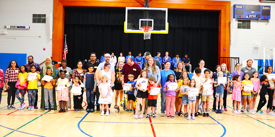 Energy Bus award recipients and their families pose during a June assembly.