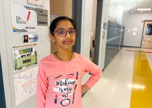 Student poses in the hallway