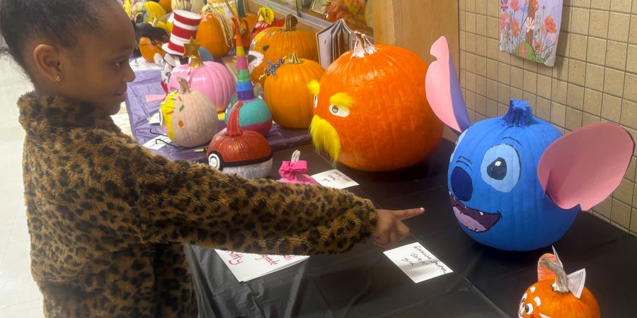 A first grade student makes a 'gourd'-eous choice for her favorite pumpkin design.