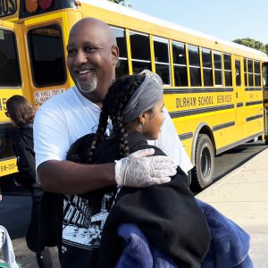 father hugs daughter
