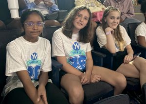 Students pose while wearing American Young Voices Tee Shirts