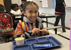 Smiling student eating
