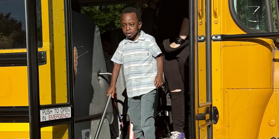 Boy stepping off bus