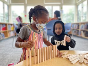 student creating with wood blocks