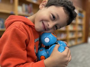 students hugs dash robot