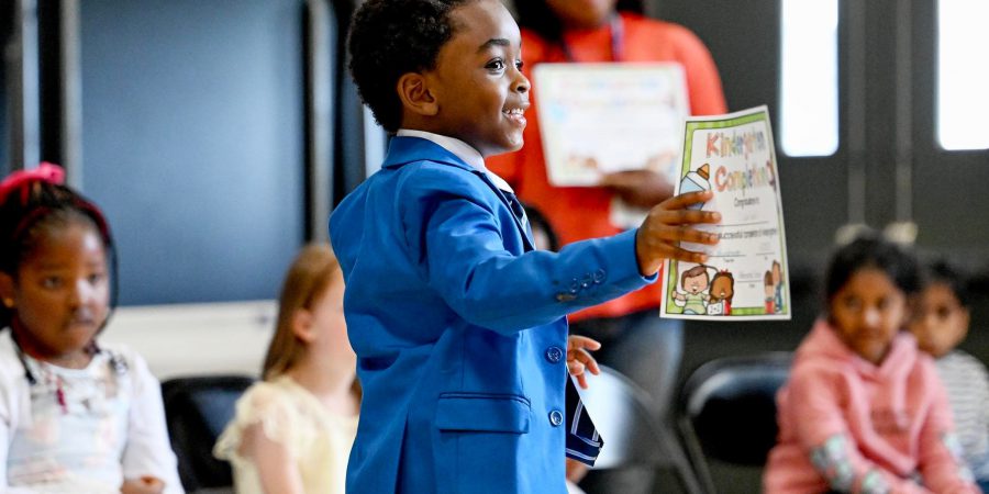 Kindergarten student celebrating graduation