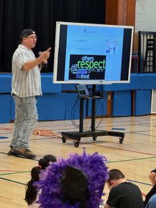 Speaker points in front of a screen