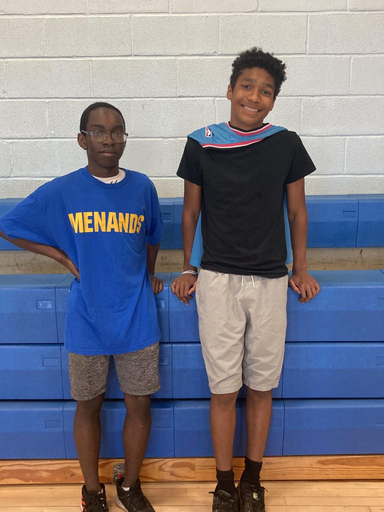 Two students smiling next to each other