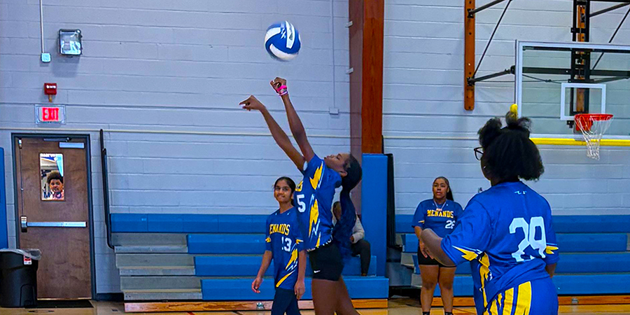 students playing volleyball